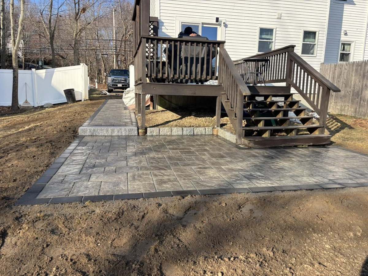 Paver patio and walkway installed beneath a rear deck